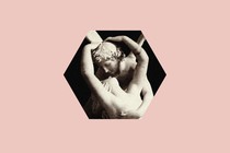 two embracing statues in a hexagonal cutout against a pink background