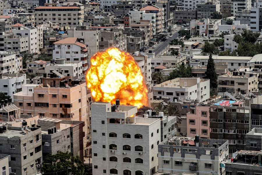 A fireball erupts among buildings in Gaza City, caused by an Israeli air strike.