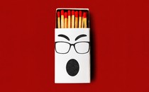 Illustration showing white, half-open matchbox, the front of which shows face with glasses and expression of outrage.