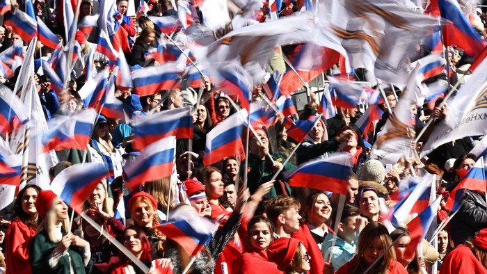 People wave Russian flags