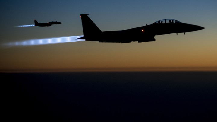A pair of U.S. Air Force F-15E Strike Eagles fly over northern Iraq after conducting airstrikes in Syria on September 23, 2014.