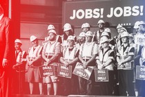 Workers in hard hats listen to Trump speak.