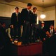In a scene from "Dead Poets Society," students stand on a desk in a classroom.