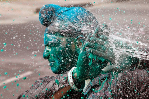 A boy reacts as water is thrown on his face while celebrating Holi (Ajay Verma / Reuters)