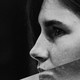 A split image shows Abigail Breslin, right, sitting at a table with her head in her hand. To the left is a photo of Amanda Knox in profile.