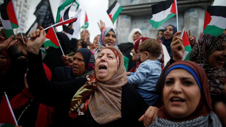 Palestinian women shout slogans during a protest in Gaza City.