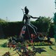 A statue of Britannia in a formal garden