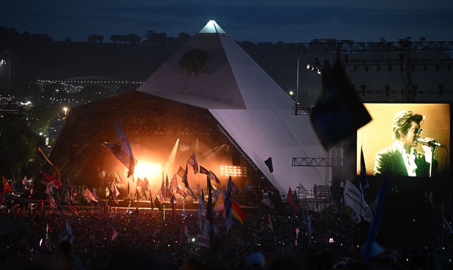 A view of a musical performance on an outdoor stage at night.