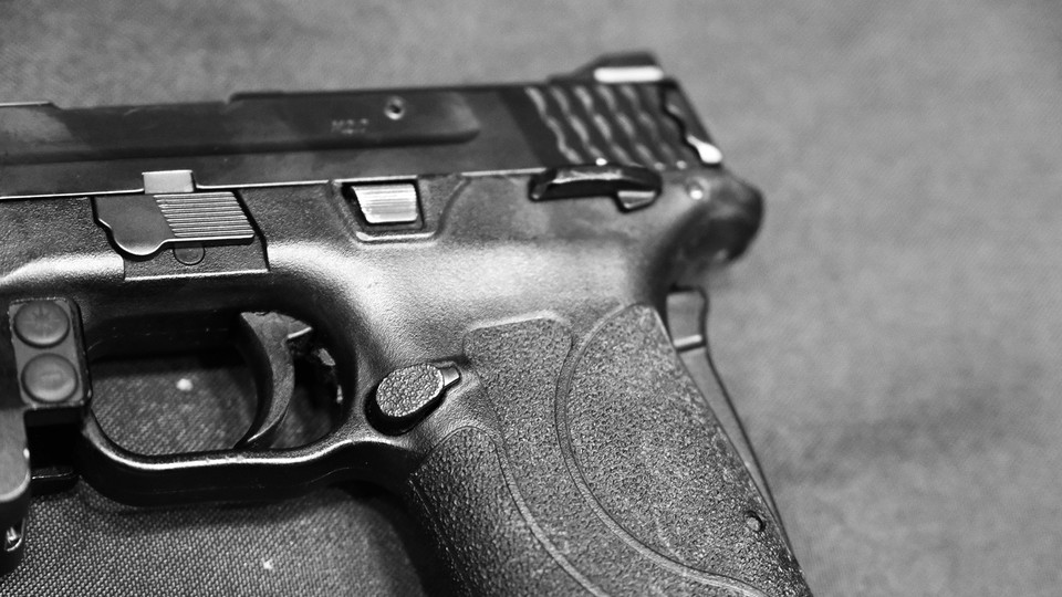 A black-and-white picture of the butt and trigger of a gun
