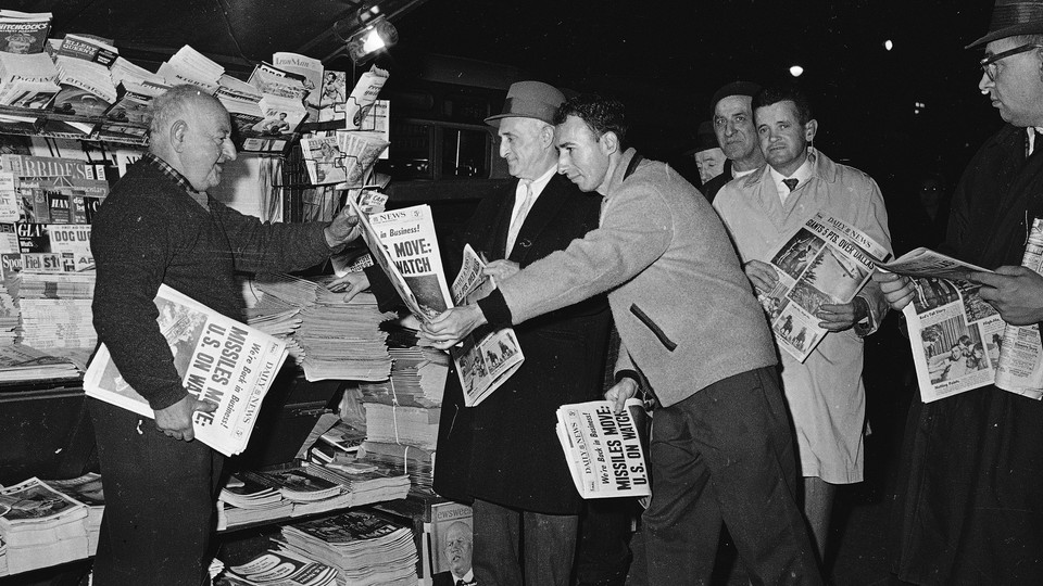 New Yorkers stop to glance at the four-star final edition of the New York Daily News in November 1962.