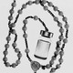 A black-and-white rosary that ends with a vaccine bottle