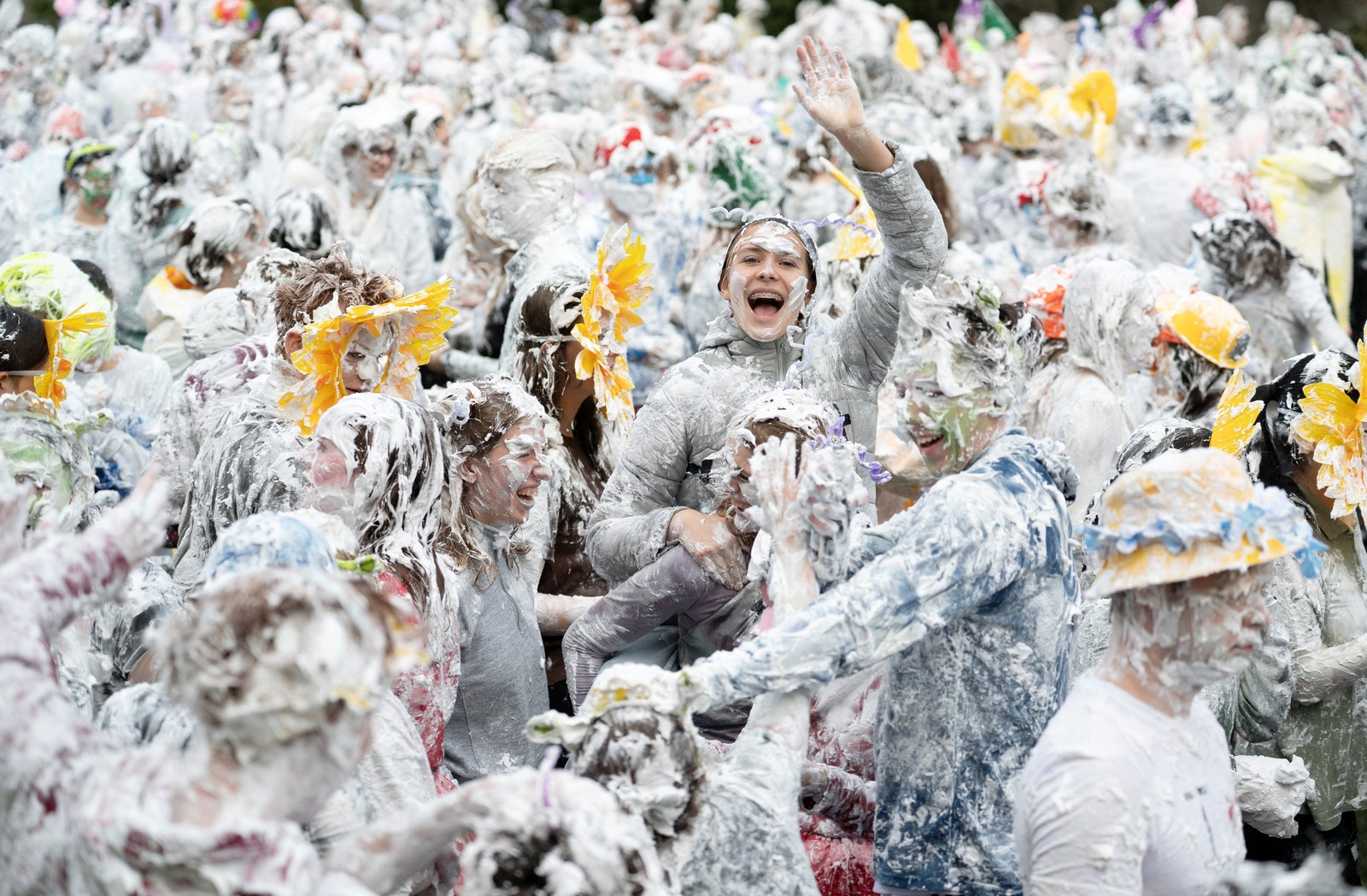 A crowd of students, all covered from head-to-toe in soap suds