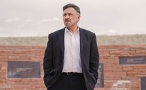 A photograph of Frank DeAngelis in front of the Columbine Memorial