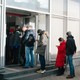 People stand in line to withdraw money from an ATM in Moscow, Russia.