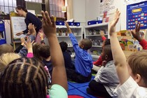 Kids, both black and white, raise their hand at Detroit Prep, an intentionally diverse school.