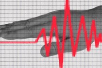 A hand overlaid with a grid and red polygraph line