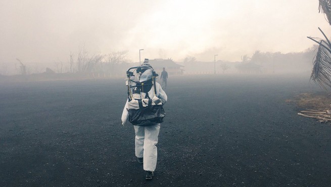 A volcanologist heading toward an active site