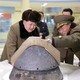 North Korean leader Kim Jong Un looks at the tip of a rocket warhead after a simulated test of atmospheric reentry of a ballistic missile.