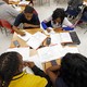 An overhead shot of students with calculators and textbooks