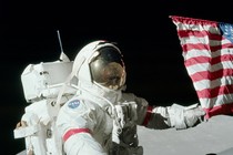 Gene Cernan holds the American flag during a spacewalk on the Apollo 17 mission on December 12, 1972. 