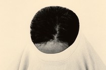 A person with their shirt pulled mostly over their head