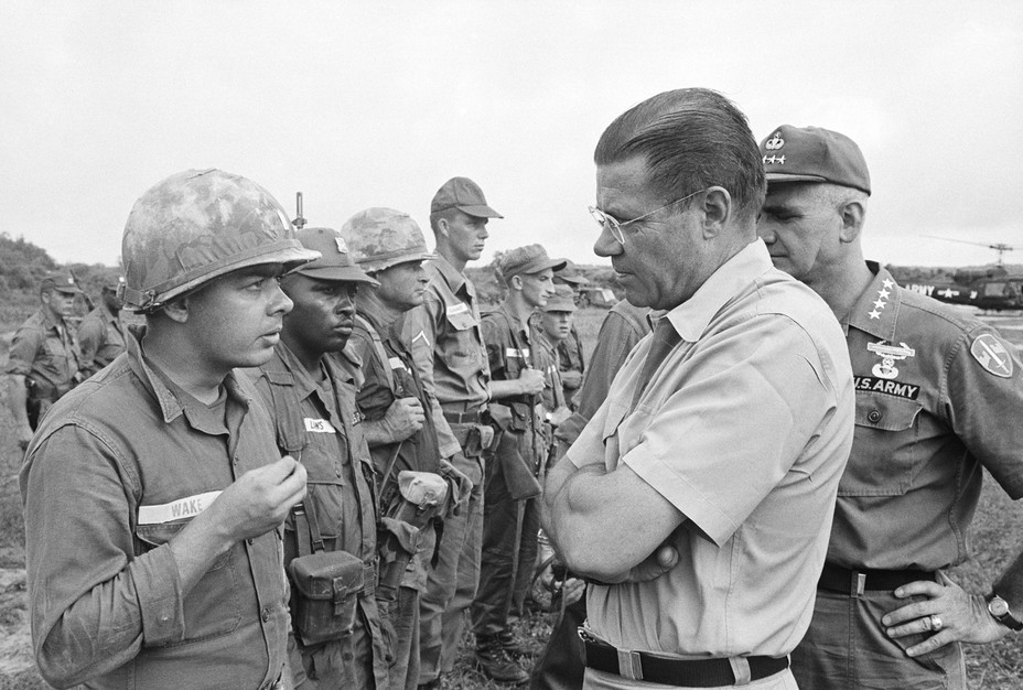 Picture of Robert S. McNamara (right) getting a first-hand opinion from a soldier in Vietnam