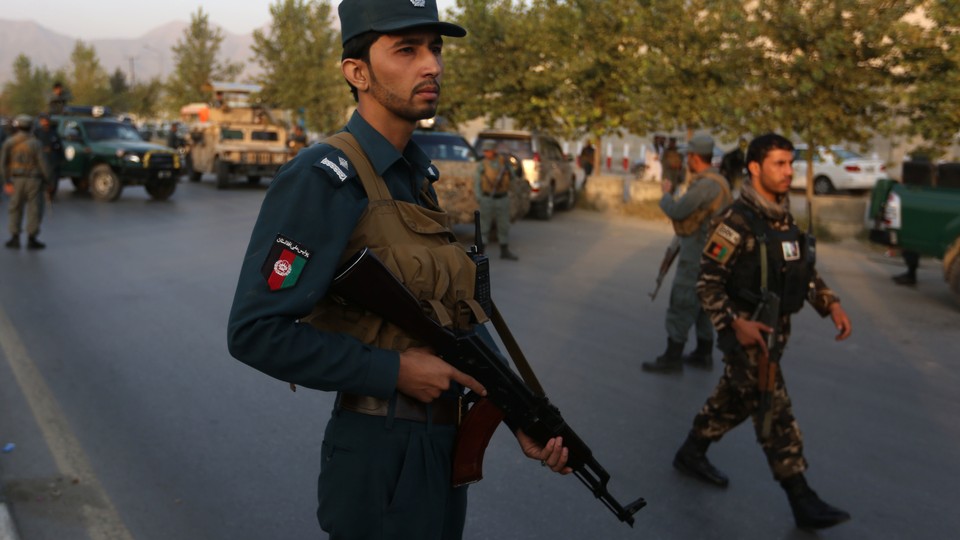 Afghan security forces stand guard after an attack on the American University of Afghanistan in Kabul, Afghanistan, on Thursday.