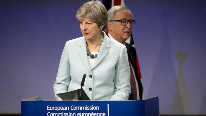 U.K. Prime Minister Theresa May and European Commission President Jean-Claude Juncker address the media at the EU headquarters in Brussels on December 8, 2017.