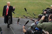 Donald Trump points somewhat menacingly at a media scrum.