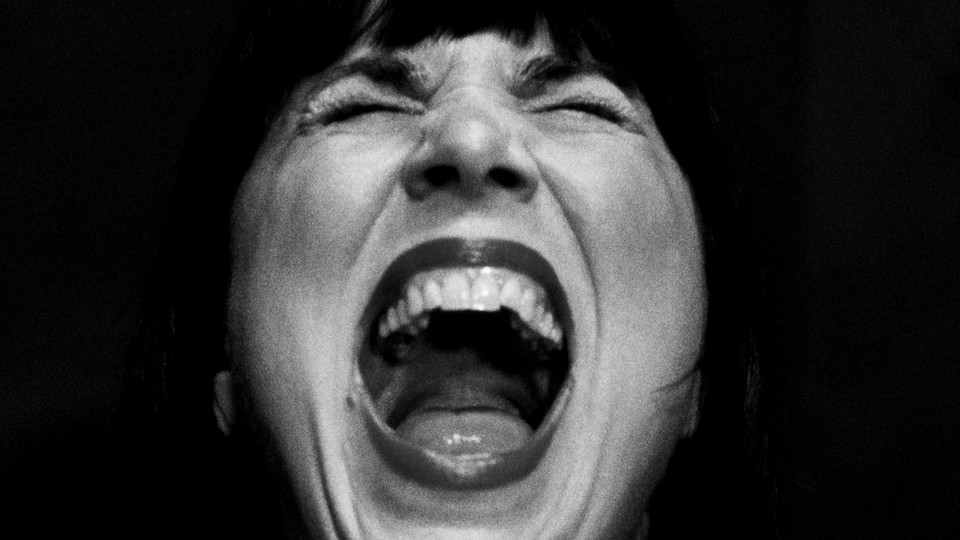 A close up of a woman screaming