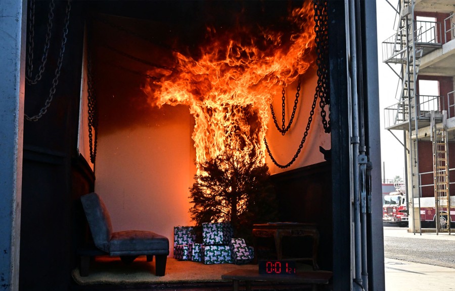 A Christmas tree goes up in flames inside a shipping container.