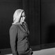 A black and white photo of Liz Cheney standing by herself