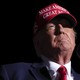 Photograph of Donald Trump with a MAGA hat on