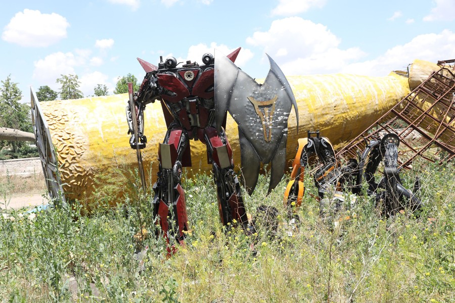 A headless robotic feature stands in a field.