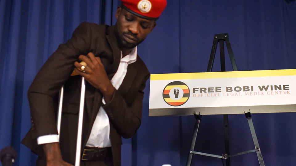 Bobi Wine stands with the support of a crutch as he gives a press conference in Washington, D.C., on September 6.