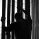 prisoner holding onto bars