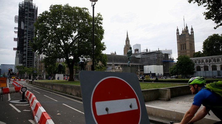 A cyclist heads past the houses of Parliament in central London.