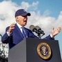 A photo of President Biden giving a speech while wearing a cap