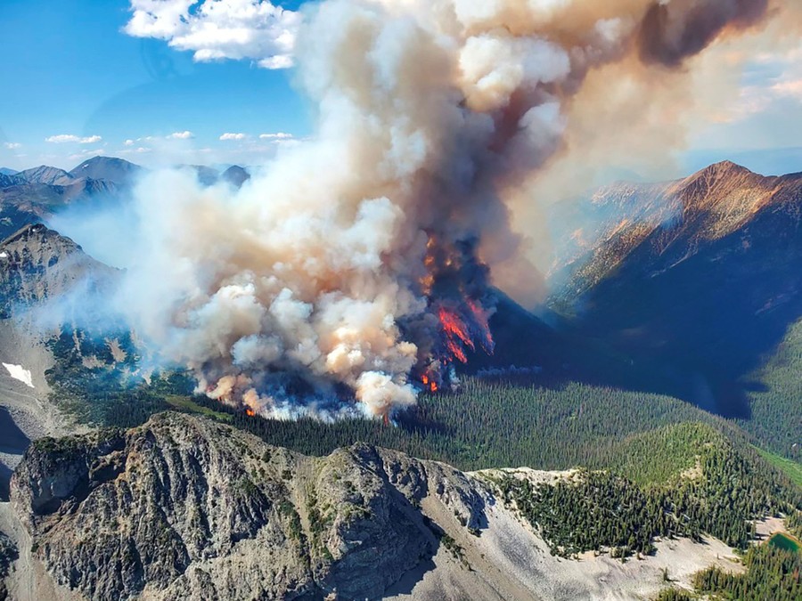 An aerial view of a forest fire burning on a mountainside