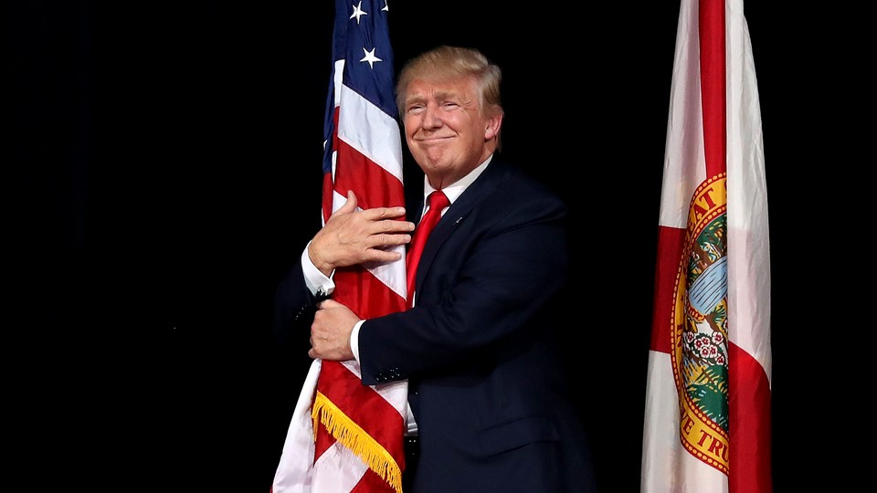 Donald Trump hugging an American flag