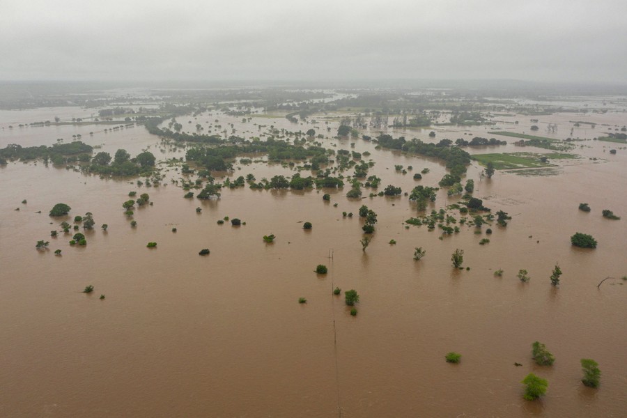 An aerial view of widespread flooding from an overflowing river.