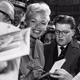 September 25, 1957; London, England, U.K. Jayne Mansfield signing autographs when she arrived at the Dorchester Hotel.