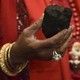 A woman holds a lump of coal
