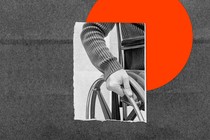 A photograph of a hand in black and white gripping the rim of a wheelchair, set against a gray background overlaid with a round orange circle reminiscent of a sun