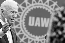 A photo of Joe Biden in front of a UAW sign