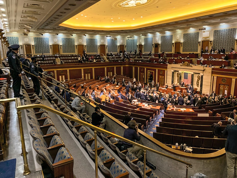 photo taken from top corner of House gallery, with police officers on left and a crowd of representatives toward the front