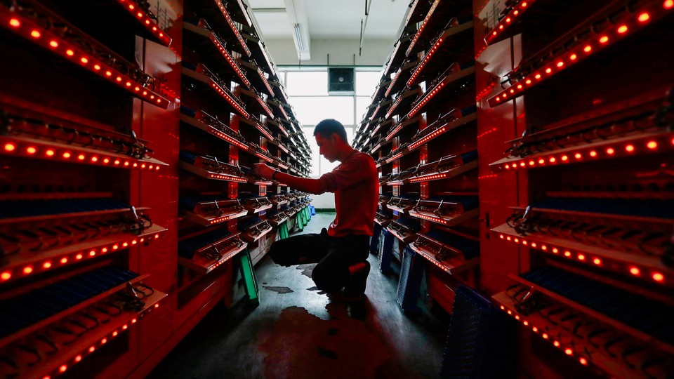 This photo taken on November 14, 2020, shows an employee working in the workshop of a lithium battery manufacturing company in Huaibei, eastern China's Anhui province
