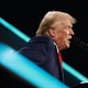 Donald Trump speaks into a microphone