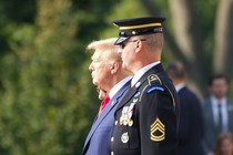 Donlad Trump stands next to an Honor Guard member during a visit to the Arlington National Cemetery