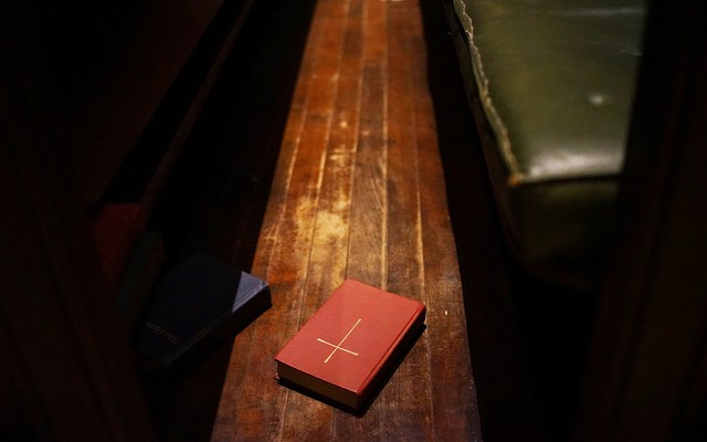 A bible on a pew.